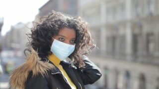 woman wearing black jacket and face mask